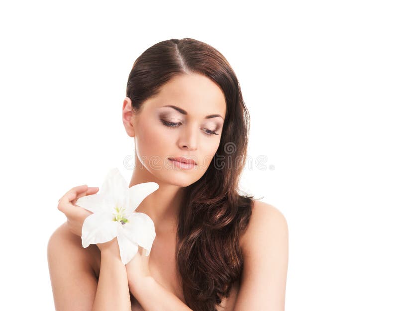 Portrait of a young woman holding a white flower