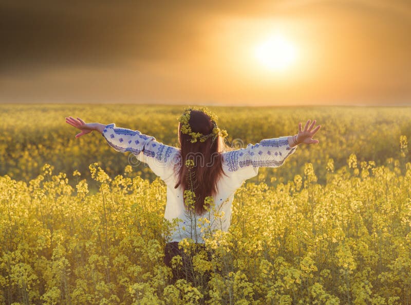 Portrait of a young woman in a rapeseed field