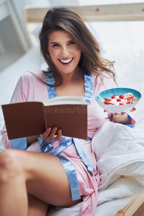 Portrait of young woman in underwear eating cereals