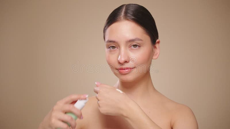 Portrait young woman uses creams of her face
