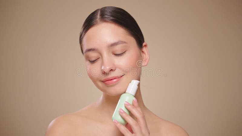Portrait young woman uses creams of her face