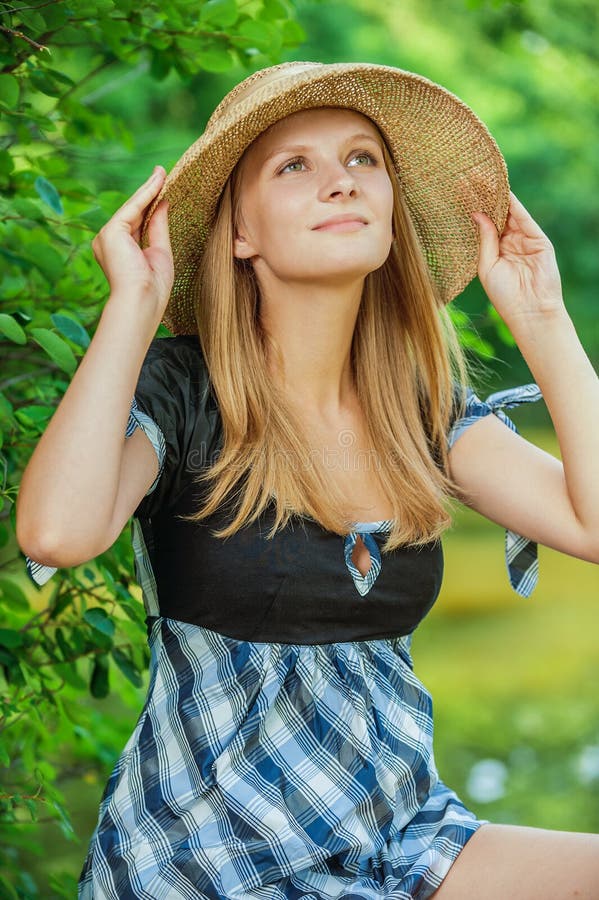 Portrait of young woman wearing straw hat