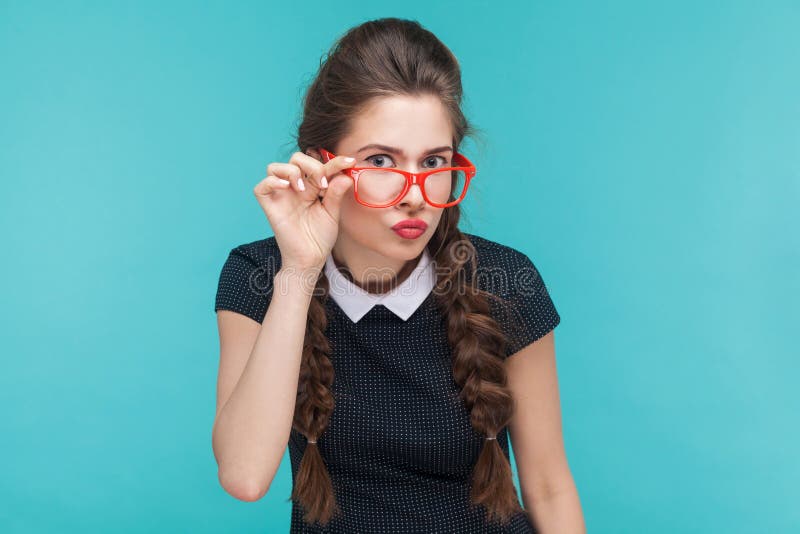 Portrait of young woman with wevy pigtails and red glasses