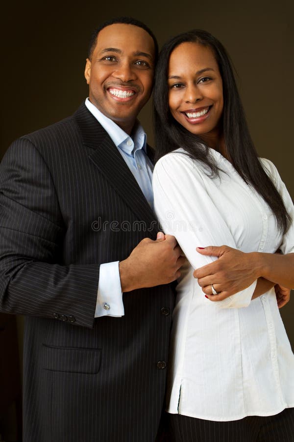 Happy African American couple hugging. Happy African American couple hugging.