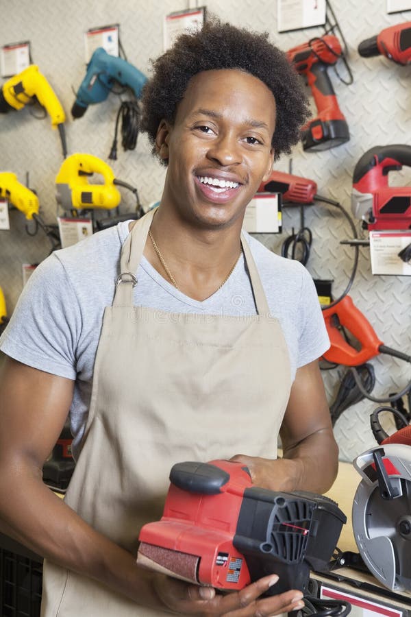 Portrait of an African American male store clerk holding electronic tool. Portrait of an African American male store clerk holding electronic tool