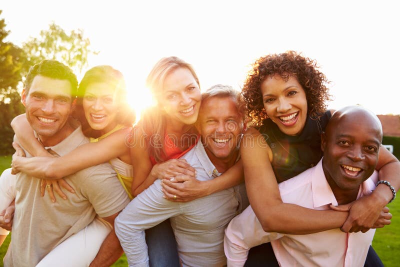 Portrait Of Mature Men Giving Women Piggy Backs. Portrait Of Mature Men Giving Women Piggy Backs