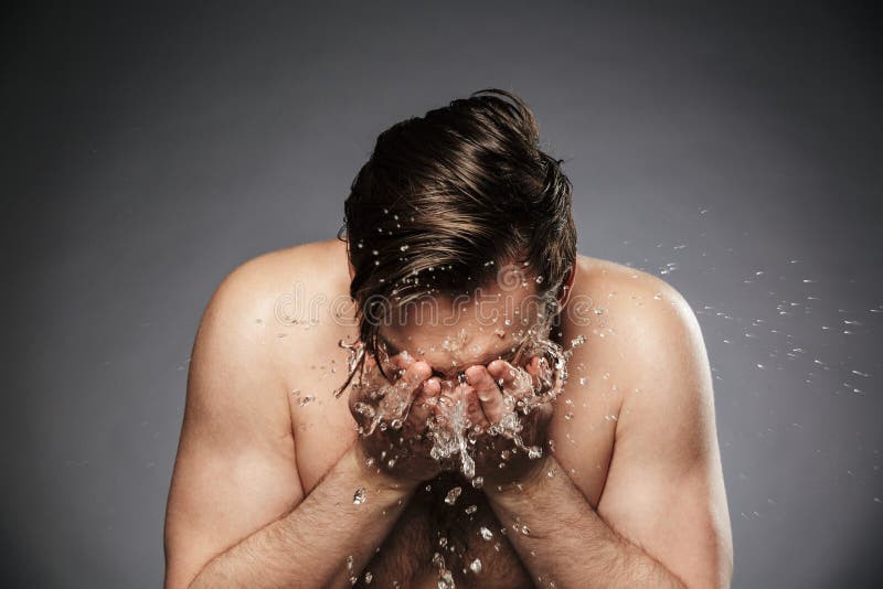 Portret jonge shirtless mens die zijn gezicht met water wassen stock foto's Portret jonge shirtless mens die zijn gezicht met water wassen stock foto's