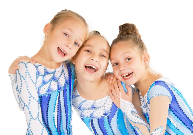 Three little gymnasts posing on white background. Three little gymnasts posing on white background