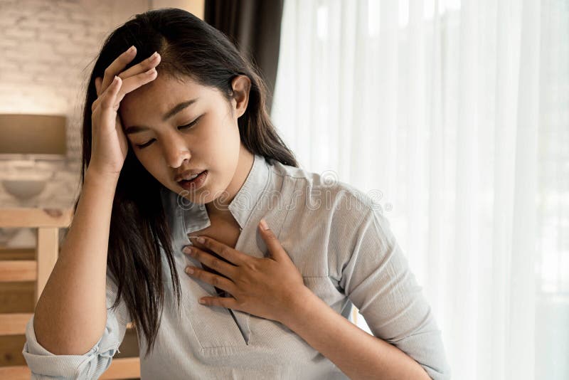 Portret 20. młodej azjatyckiej kobiety mającej trudności z oddychaniem w sypialni w nocy. astma duszna