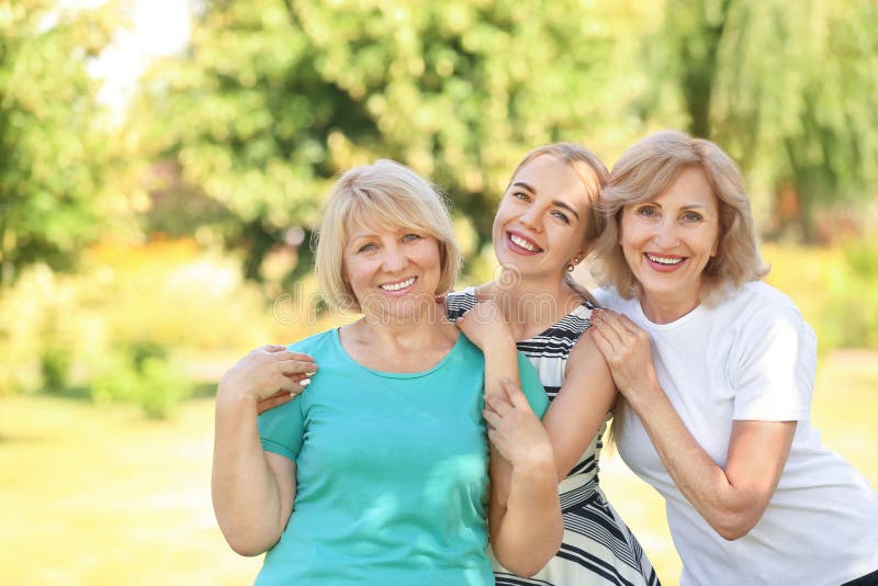 Portrait of beautiful mature women and young girl outdoors. Portrait of beautiful mature women and young girl outdoors