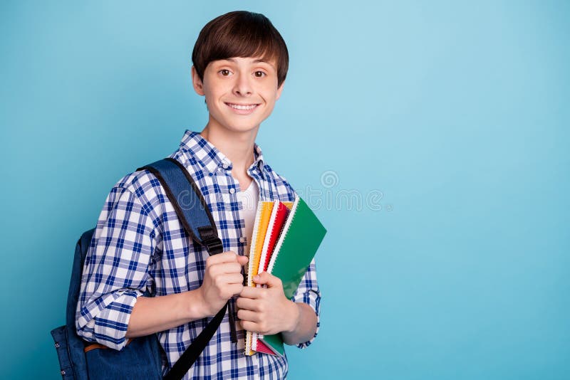 Portret van charmante de notaboeken die van de studentholding worden geïsoleerd dragend gecontroleerd overhemd kijken die over bl stock afbeeldingen Portret van charmante de notaboeken die van de studentholding worden geïsoleerd dragend gecontroleerd overhemd kijken die over bl stock afbeeldingen