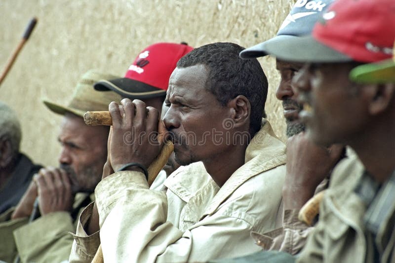 ETHIOPIA, region Oromia, Koka village: Meeting of Oromo, Ethiopian largest ethnic population group, elderly, old, wise men about buying or selling grain. Group portrait of heads of men, Ethiopians, who participate in this meeting. People, peasants, live in the countryside under poor living conditions, poverty. Portrait of old man, who concentrated listening to a speaker. His head, mouth, chin, he relies on his walking stick. ETHIOPIA, region Oromia, Koka village: Meeting of Oromo, Ethiopian largest ethnic population group, elderly, old, wise men about buying or selling grain. Group portrait of heads of men, Ethiopians, who participate in this meeting. People, peasants, live in the countryside under poor living conditions, poverty. Portrait of old man, who concentrated listening to a speaker. His head, mouth, chin, he relies on his walking stick.