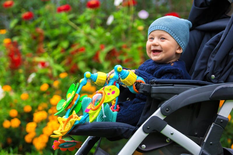 Portret van een gelukkig kind in een kinderwagen in openlucht stock afbeeldingen Portret van een gelukkig kind in een kinderwagen in openlucht stock afbeeldingen