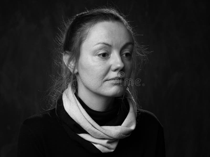 Portrait of a young sad disoriented woman in white scarf, grey background. Portrait of a young sad disoriented woman in white scarf, grey background