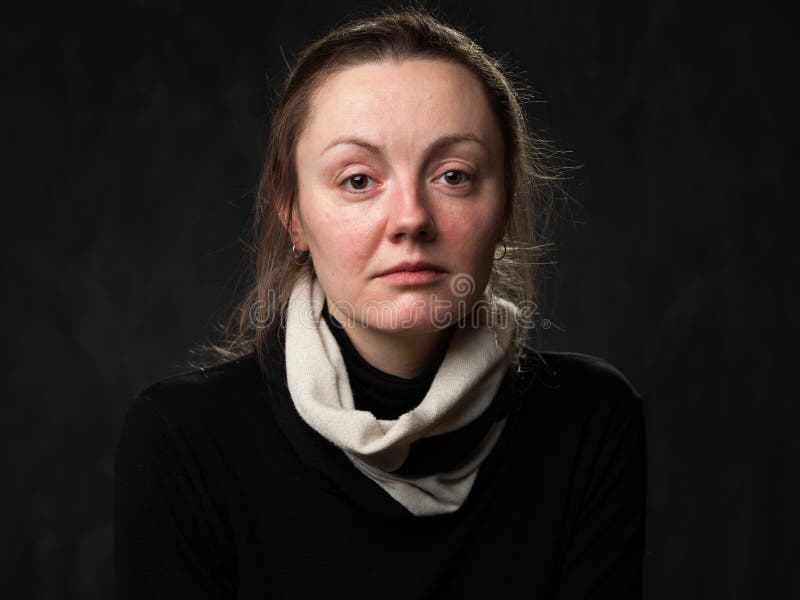 Portrait of a young sad disoriented woman in white scarf, grey background. Portrait of a young sad disoriented woman in white scarf, grey background