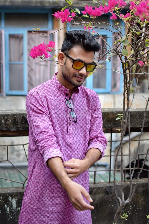Portret van een jonge en knappe Indische Bengaalse mens die zich voor een uitstekend huis bevinden die groene Indische traditione stock foto's Portret van een jonge en knappe Indische Bengaalse mens die zich voor een uitstekend huis bevinden die groene Indische traditione stock foto's