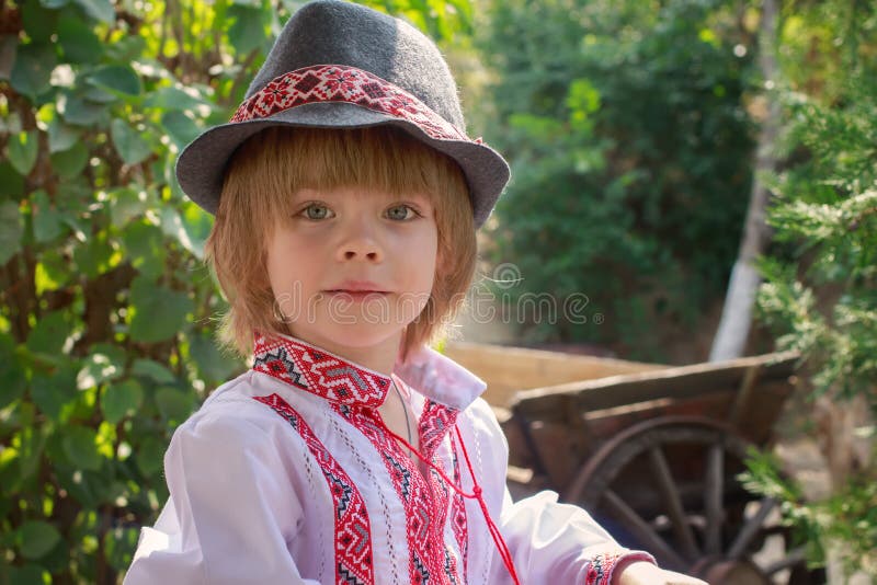 Portret van een kleine jongen in een wit geborduurd overhemd en een hoed royalty-vrije stock fotografie Portret van een kleine jongen in een wit geborduurd overhemd en een hoed royalty-vrije stock fotografie