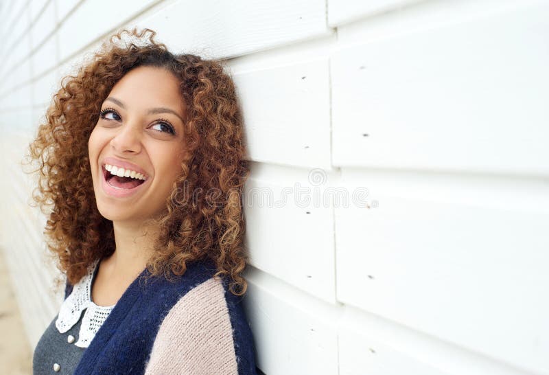 Close up portrait of a beautiful young woman laughing and looking away. Close up portrait of a beautiful young woman laughing and looking away