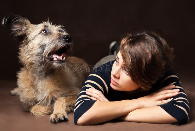 Portret van een mooie jonge vrouw met een grappige ruwharige hond op a stock fotografie Portret van een mooie jonge vrouw met een grappige ruwharige hond op a stock fotografie