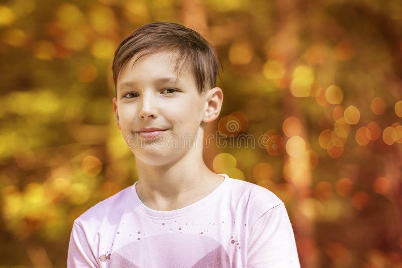 Portrait of an approximately 11-year-old boy. Nice bokeh in the background. Portrait of an approximately 11-year-old boy. Nice bokeh in the background.