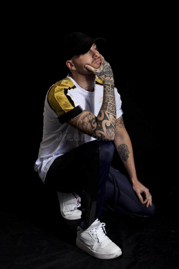 Portrait of young rapper in the studio on a black background. Portrait of young rapper in the studio on a black background