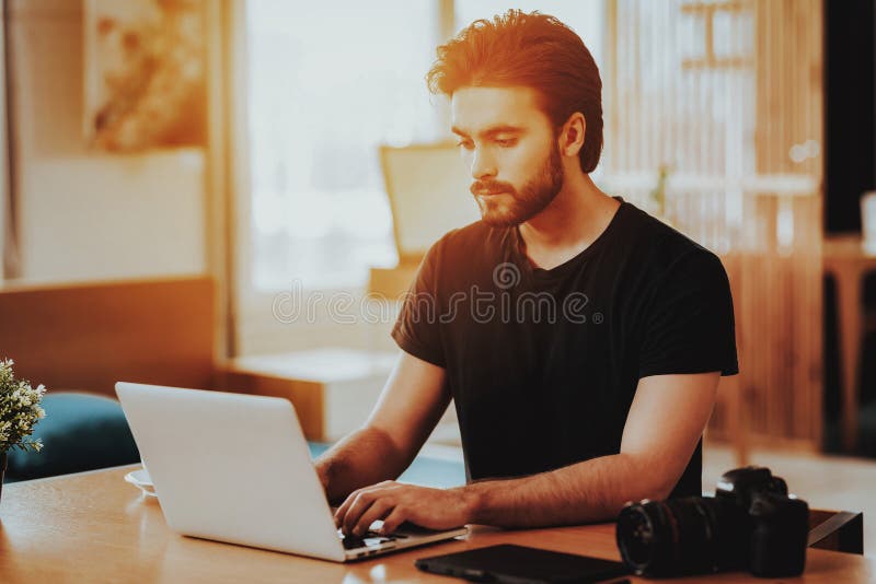 Portret van Knappe Freelancer die aan Laptop werken royalty-vrije stock afbeelding Portret van Knappe Freelancer die aan Laptop werken royalty-vrije stock afbeelding