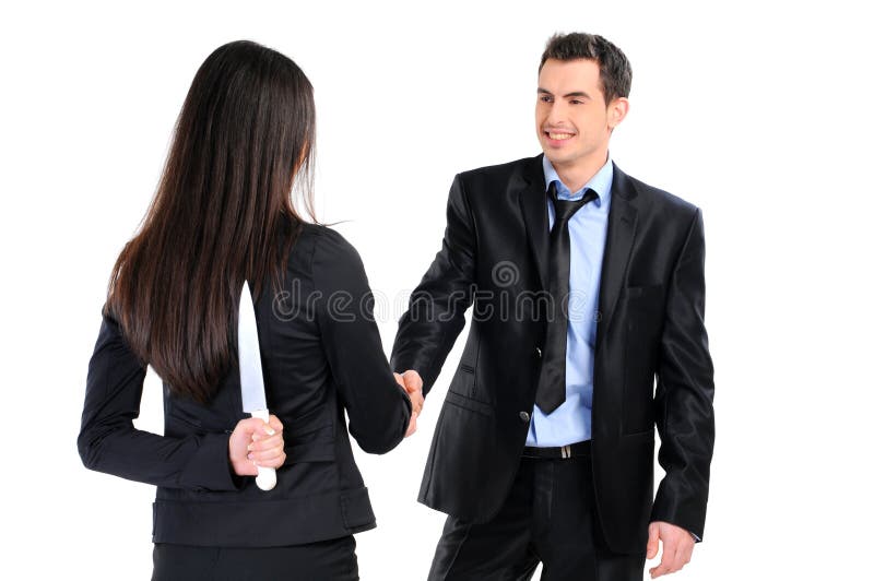 Portrait of business partners handshaking while female holding knife behind her back. Portrait of business partners handshaking while female holding knife behind her back