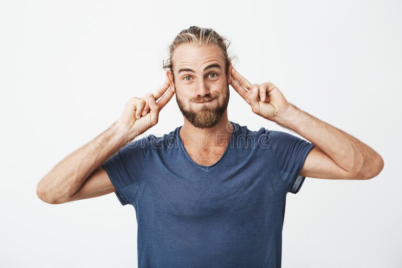 Portret śmieszny przystojny mężczyzna z brodą robi niemądrym twarzom i gestykuluje z rękami przyciągać uwagę płacz obrazy stock Portret śmieszny przystojny mężczyzna z brodą robi niemądrym twarzom i gestykuluje z rękami przyciągać uwagę płacz obrazy stock