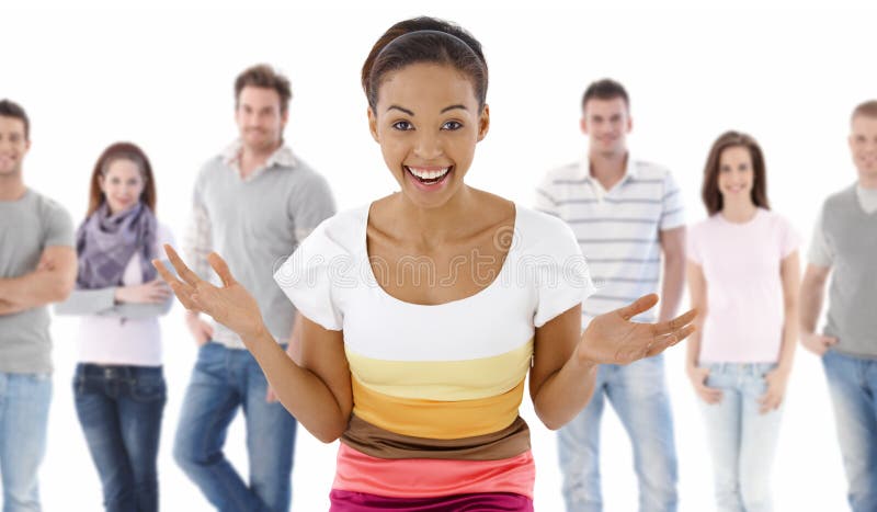 Group portrait of happy young people together, looking at camera, smiling. Young woman at front. Group portrait of happy young people together, looking at camera, smiling. Young woman at front.