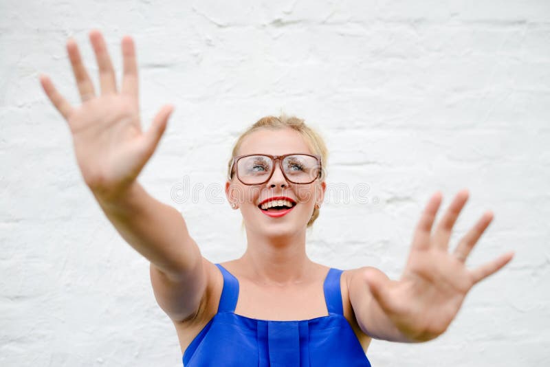 Porträt des glücklichen schönen blonden Mädchens wirft oben ihre Hände in Ergreifungsbewegung stockbild Porträt des glücklichen schönen blonden Mädchens wirft oben ihre Hände in Ergreifungsbewegung stockbild