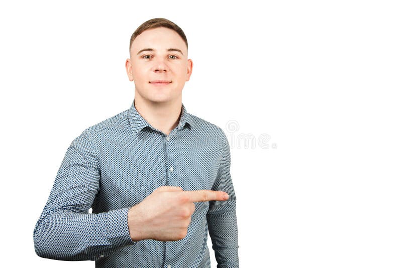 Portrait of handsome young guy dressed in blue shirt shows index finger up and smiles. Isolated on a white background. Portrait of handsome young guy dressed in blue shirt shows index finger up and smiles. Isolated on a white background