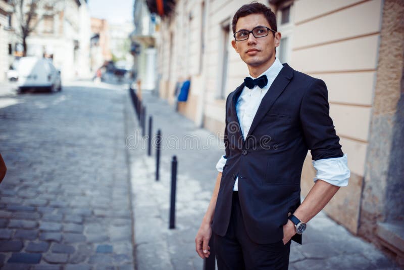 Portrait of fashionable well dressed man posing outdoors looking away. Portrait of fashionable well dressed man posing outdoors looking away.