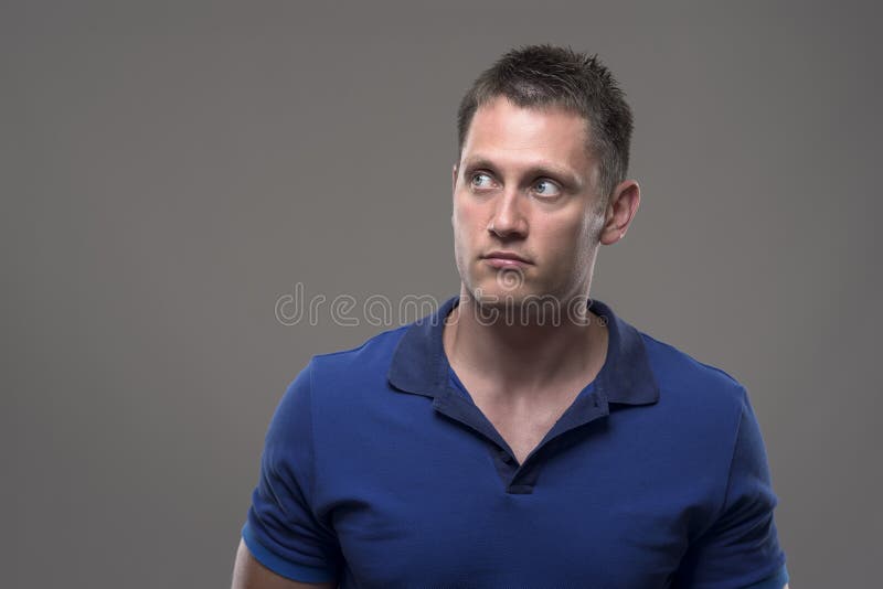 Porträt des verwirrten jungen erwachsenen Mannes, der oben Kopienraum betrachtet lizenzfreie stockfotografie
