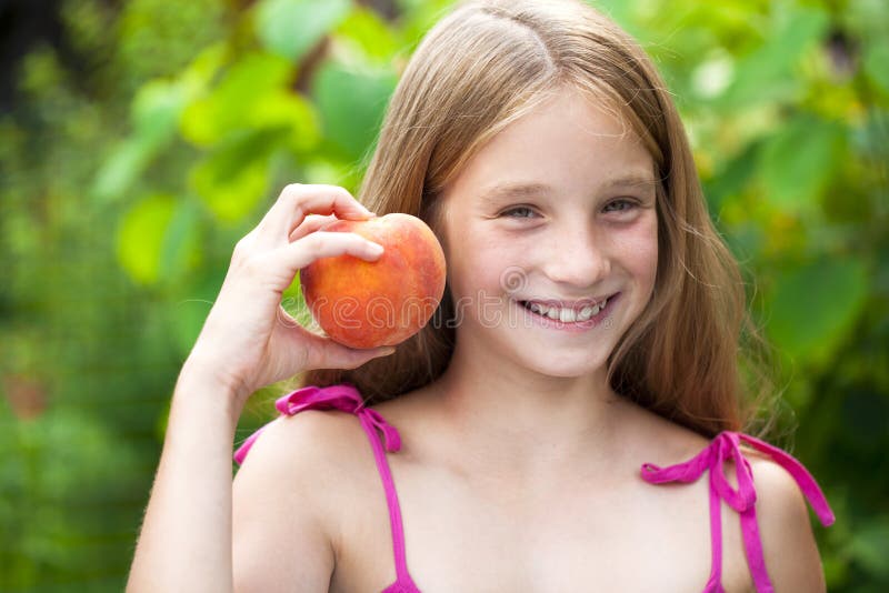 Porträt eines jungen blonden kleinen Mädchens mit Pfirsich stockbilder Porträt eines jungen blonden kleinen Mädchens mit Pfirsich stockbilder