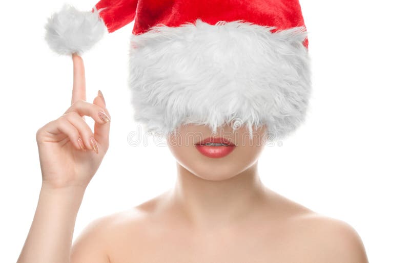 Portrait of a beautiful girl dressed in Santa Claus hat, with a beautiful make-up. New Year`s and Cosmetology concept. Portrait of a beautiful girl dressed in Santa Claus hat, with a beautiful make-up. New Year`s and Cosmetology concept.