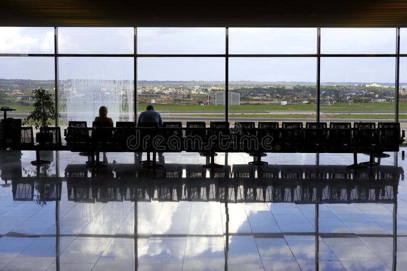 Two passengers waiting in airport lounge, palma airport, mallorca, majorca, spain. Two passengers waiting in airport lounge, palma airport, mallorca, majorca, spain