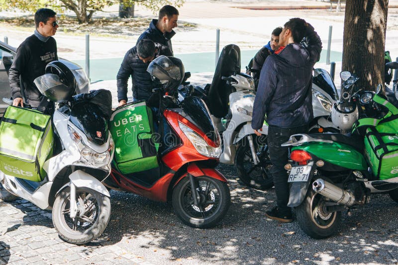 Portugal, Lisbon 29 april 2018: workers Uber Eats on the scooter delivers food to customers. royalty free stock images Portugal, Lisbon 29 april 2018: workers Uber Eats on the scooter delivers food to customers. royalty free stock images