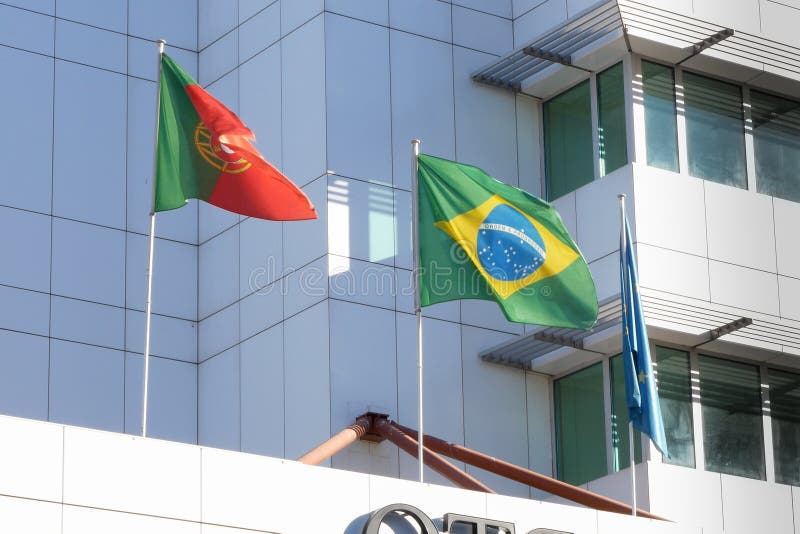 Portuguese and Brazilian flags flying side by side on a building in Porto, Portugal stock photo Portuguese and Brazilian flags flying side by side on a building in Porto, Portugal stock photo