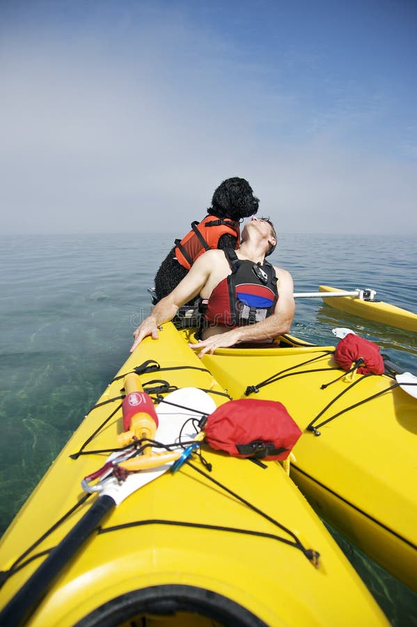 Portuguese Water Dog on Yellow Kayak