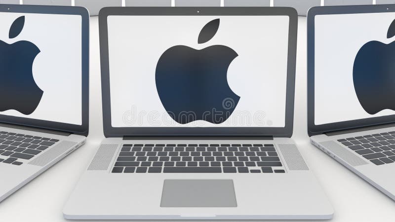 Portáteis com Apple Inc logotipo na tela Entrada moderna do prédio de escritórios Editorial conceptual 3D da informática