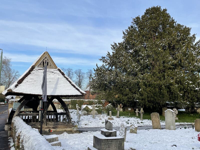 Image of a medieval lych gate in a snowy churchyard in Surrey England. Image of a medieval lych gate in a snowy churchyard in Surrey England