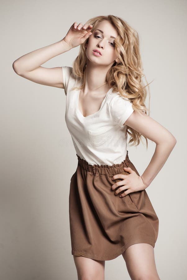 Posing blond woman with long curly hair on white royalty free stock photos Posing blond woman with long curly hair on white royalty free stock photos