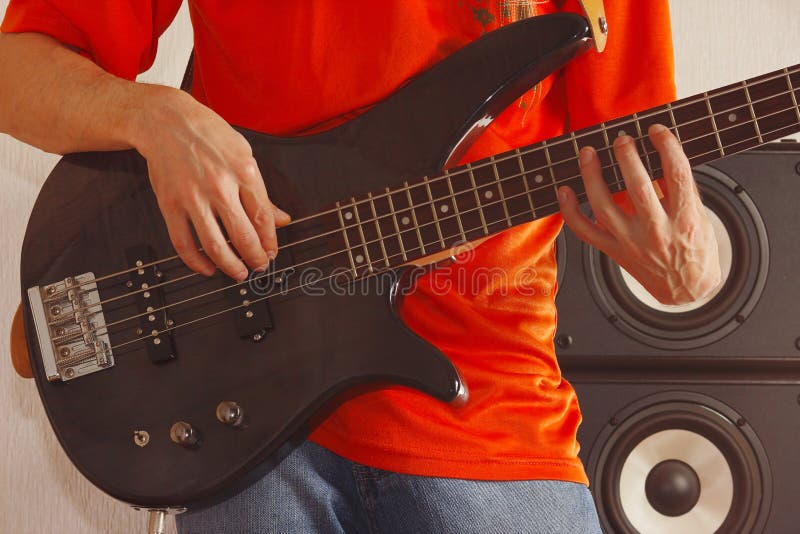 Posing Hands of Rock Musician Playing the Bass Guitar Stock Image