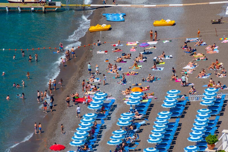 Positano, Italy, May 21, 2022 Blue and White Umbrellas at Posit