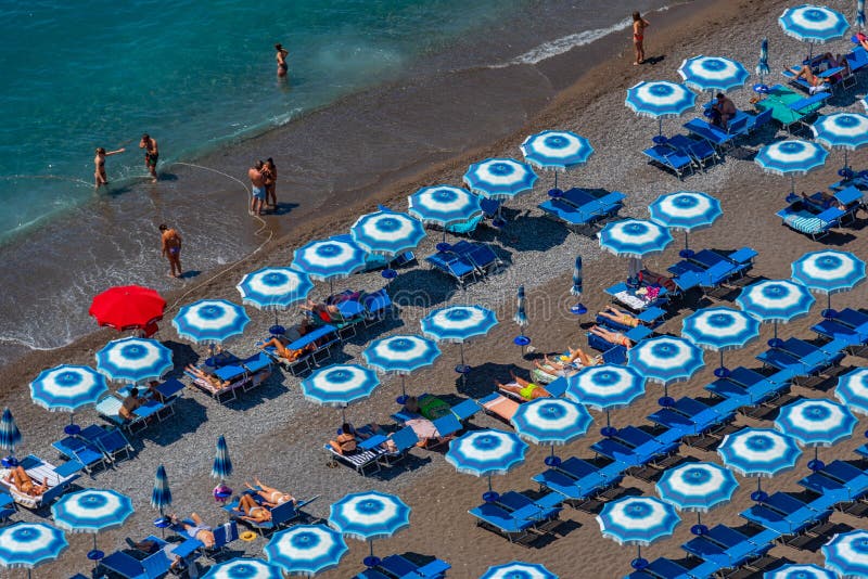 Positano, Italy, May 21, 2022 Blue and White Umbrellas at Posit