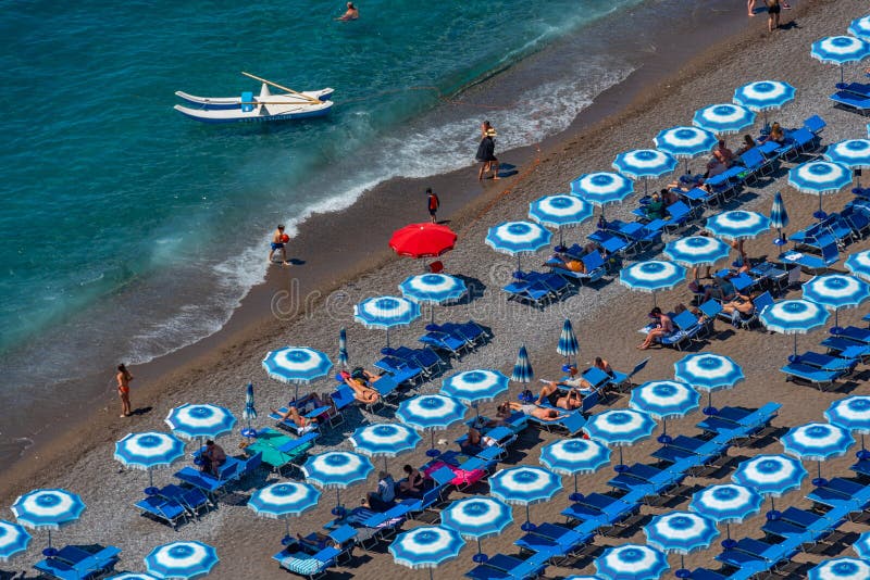 Positano, Italy, May 21, 2022 Blue and White Umbrellas at Posit