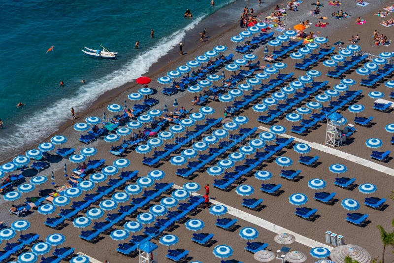 Positano, Italy, May 21, 2022 Blue and White Umbrellas at Posit