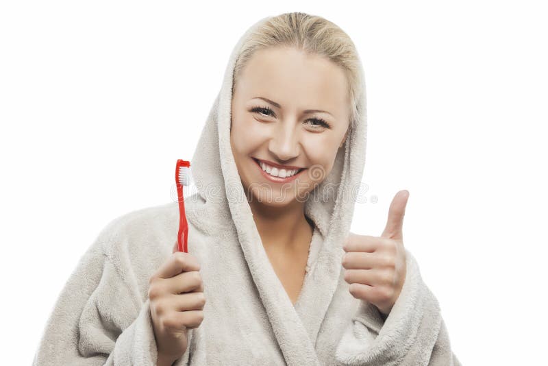 Positieve Jonge Blonde Vrouw met Handtandenborstel die Duimen tonen royalty-vrije stock afbeeldingen Positieve Jonge Blonde Vrouw met Handtandenborstel die Duimen tonen royalty-vrije stock afbeeldingen