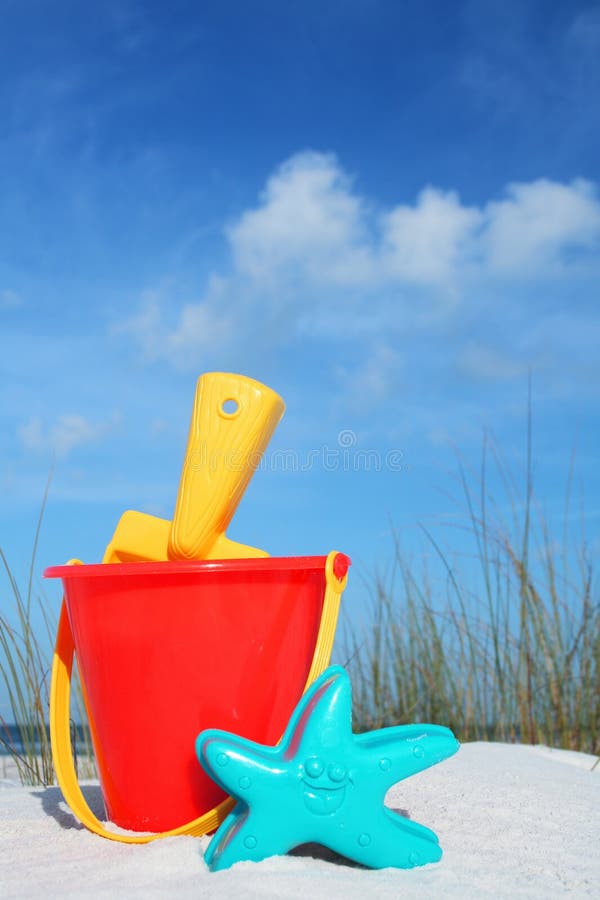 Red bucket and spade on the beach. Red bucket and spade on the beach