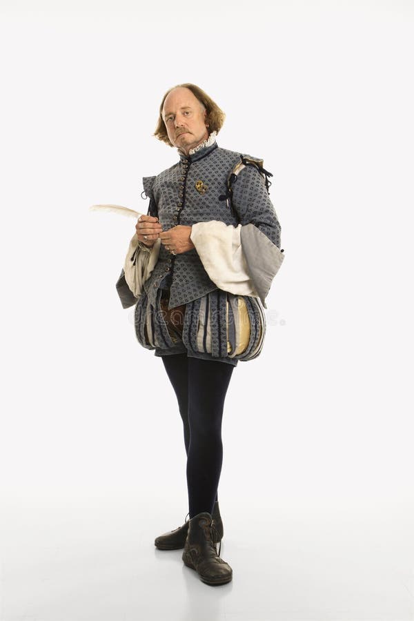 William Shakespeare in period clothing holding feather pen looking at viewer. William Shakespeare in period clothing holding feather pen looking at viewer.